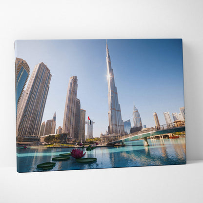 Canvas wall art featuring a modern city skyline with tall skyscrapers, blue sky, and reflective water.