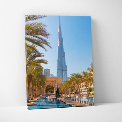 Vertical canvas art of the Burj Khalifa with palm trees and reflective pool in Dubai wall art.