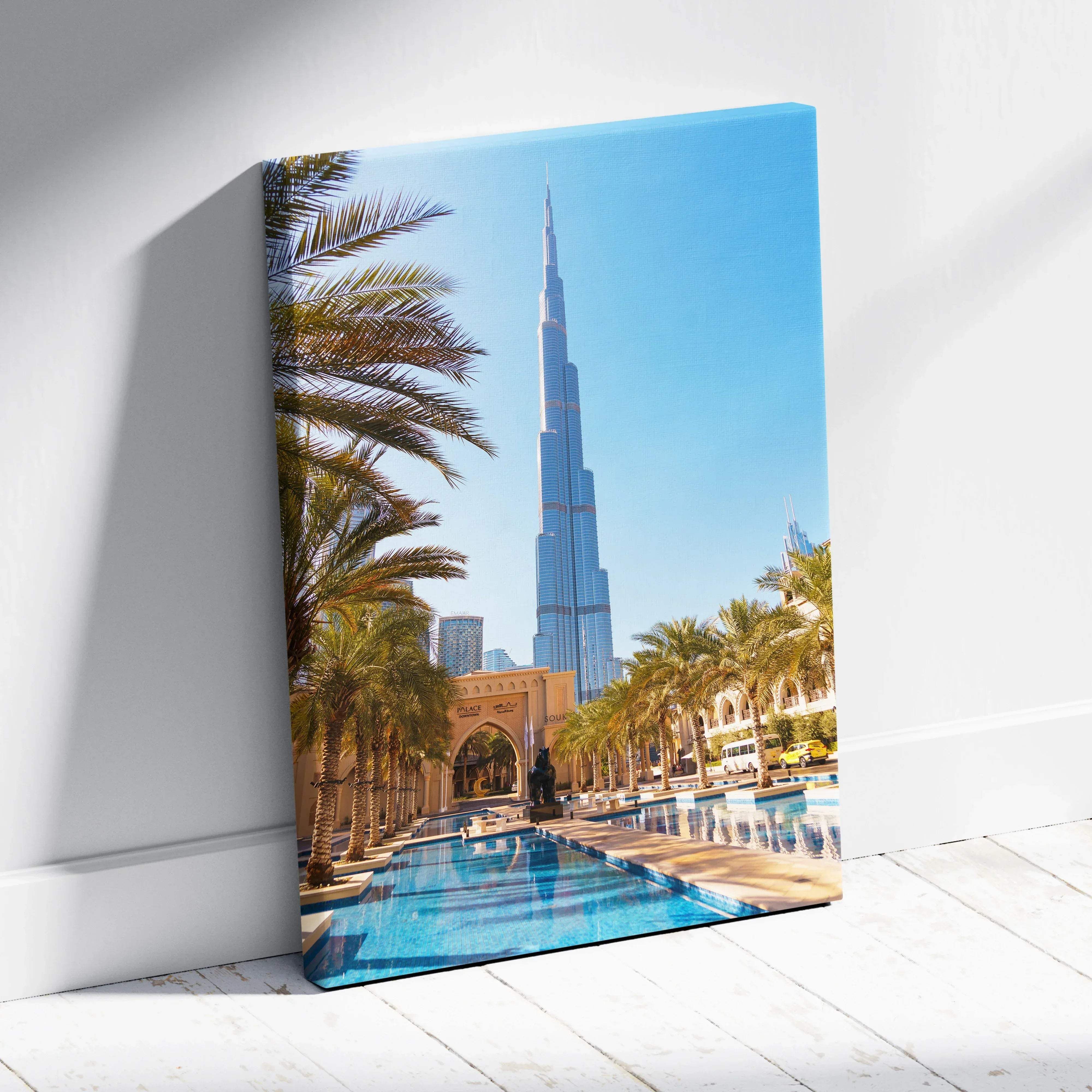 Vibrant canvas wall art featuring burj khalifa dubai skyline with palm trees and reflective pool under bright blue sky