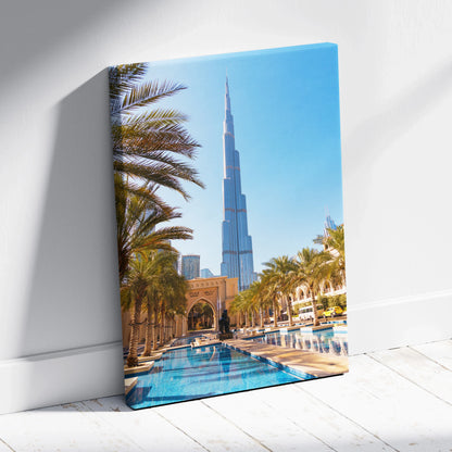 High-resolution canvas art showing a tall modern skyscraper with palm trees and a reflective pool in foreground against a.