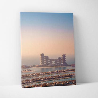 Canvas wall art featuring a high-resolution digital print of modern buildings at sunset with soft pastel sky colors.