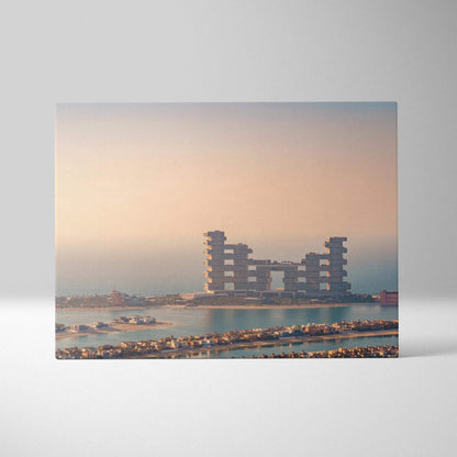 Canvas wall art featuring a modern architectural building with symmetrical towers against a soft pastel sky at sunset.