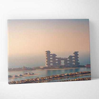 Canvas wall art featuring digital architecture of block-style buildings on water during sunset with soft pastel sky.
