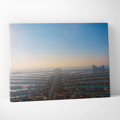 Canvas art of a cityscape at sunrise with rows of buildings and soft blue sky wall art.