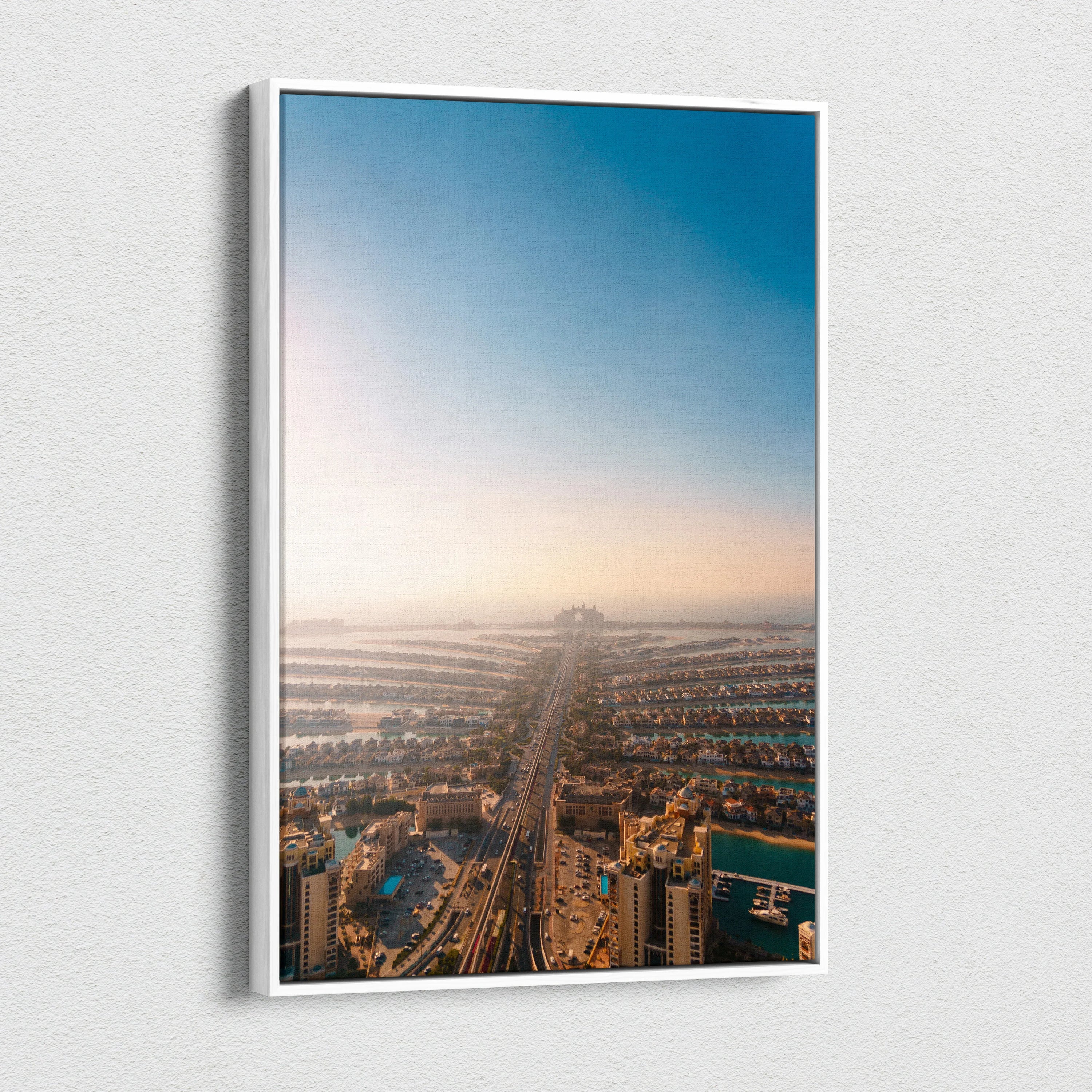 Vertical canvas wall art featuring a soft-focus urban landscape with buildings under a gradient blue sky.