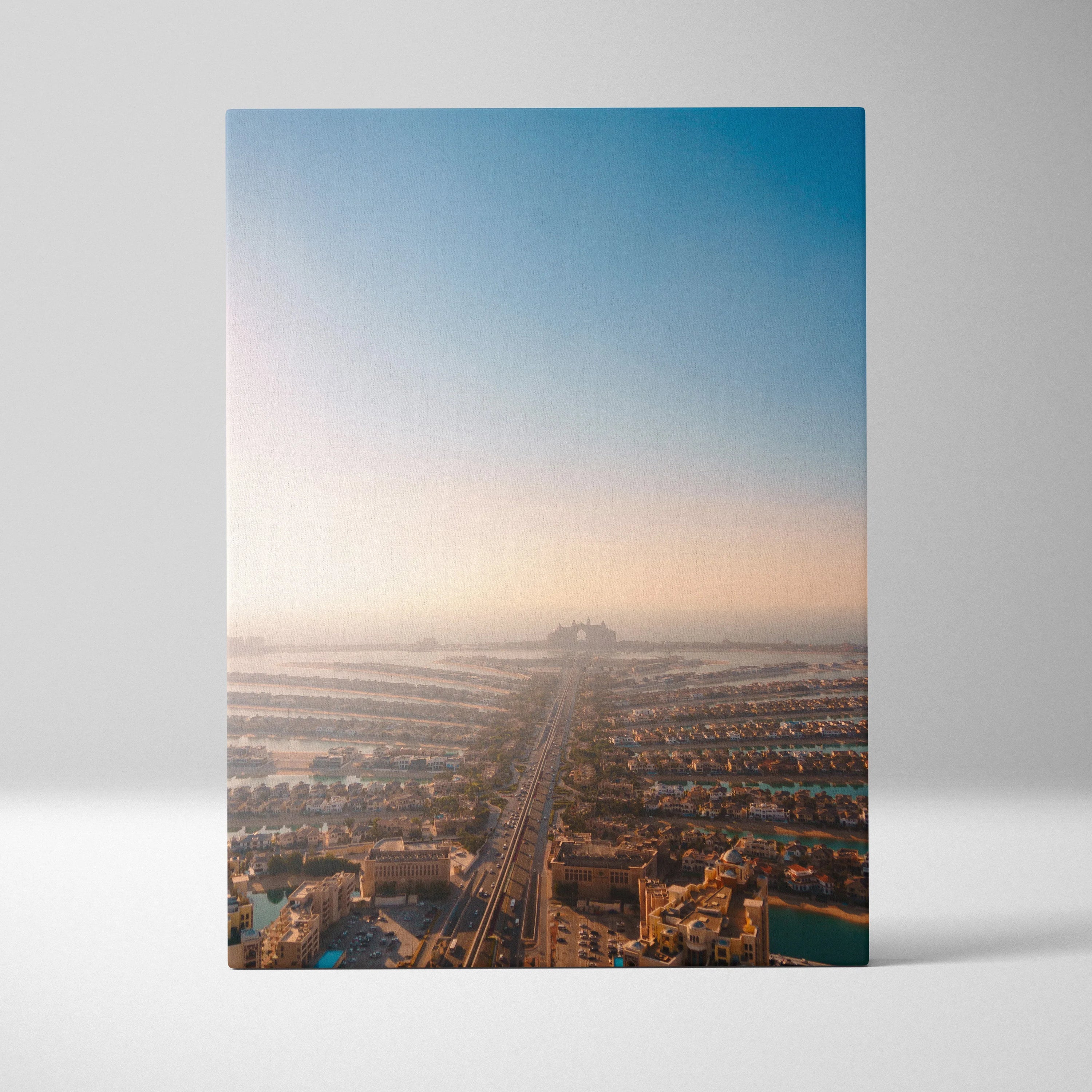 Urban landscape canvas wall art featuring aerial city view at sunrise with soft blue sky and warm tones.