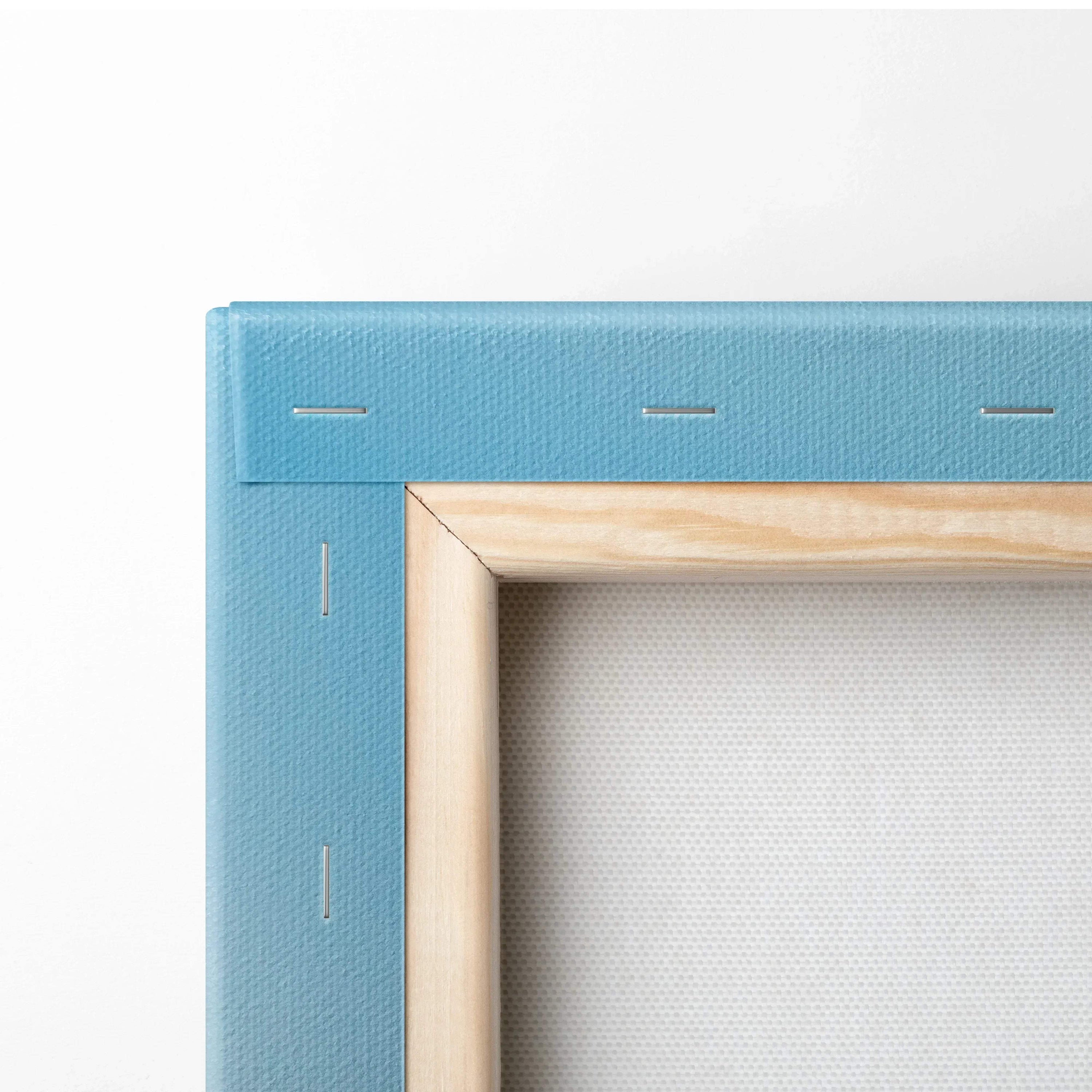 Close-up of corner on blue-stretched canvas with wooden frame and visible staples for wall art.
