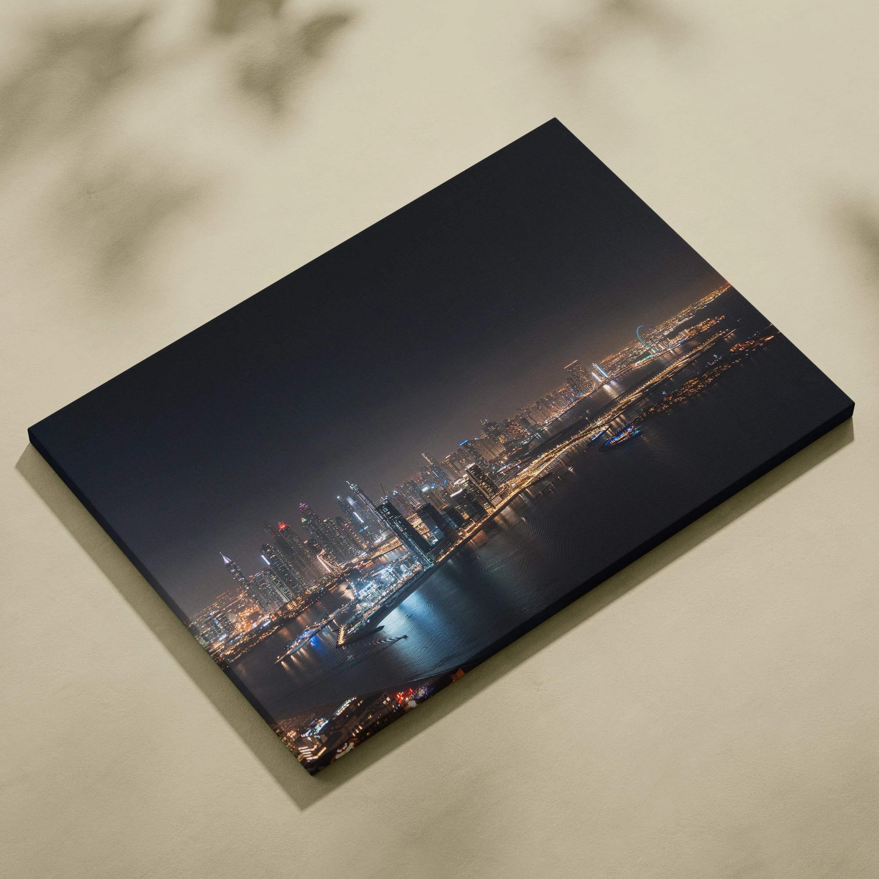 Canvas wall art featuring a nighttime city skyline with illuminated buildings and reflections on water.