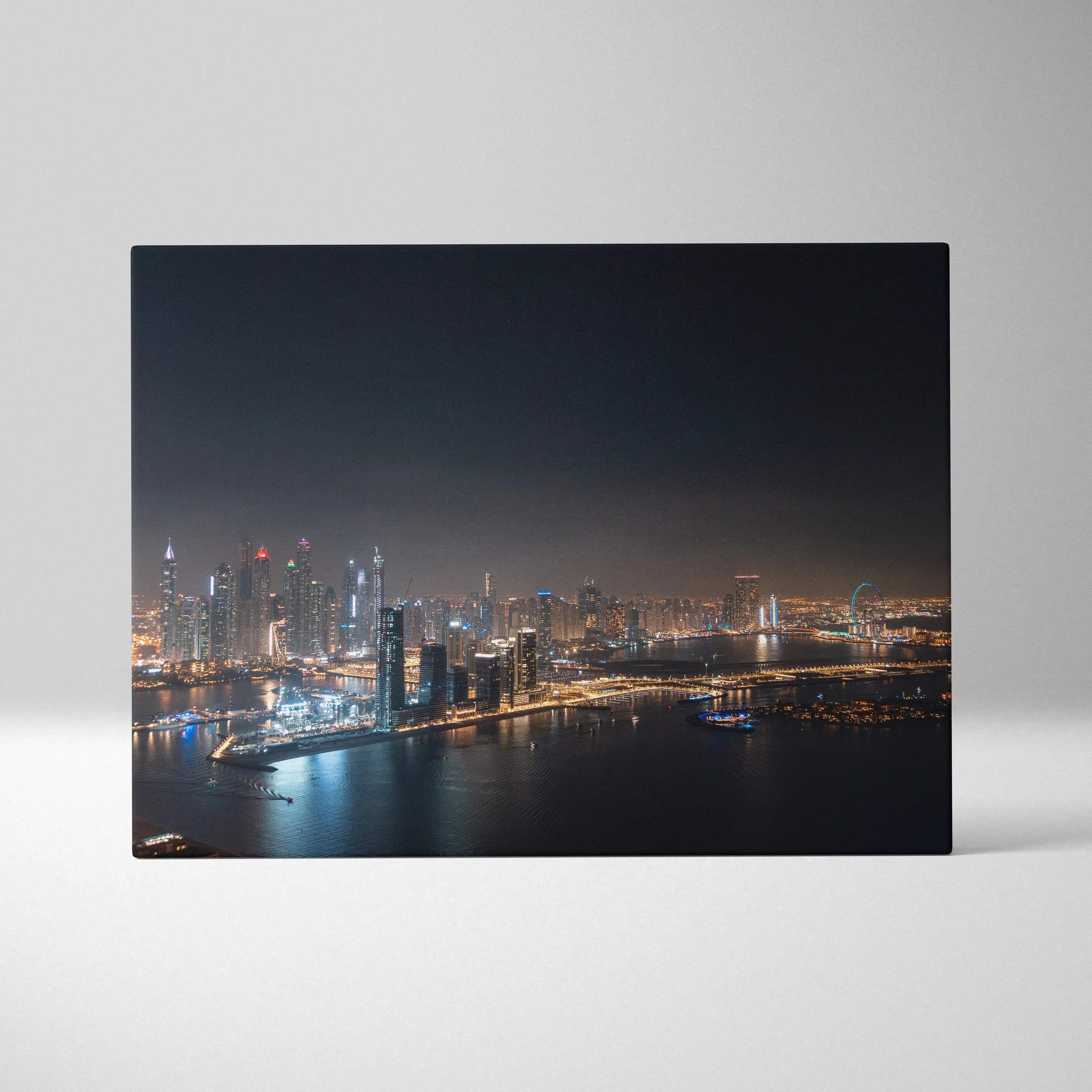 Canvas wall art print featuring a nighttime city skyline with illuminated modern buildings and reflective water.