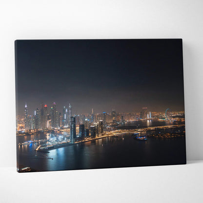 Canvas wall art featuring a vibrant nighttime cityscape with illuminated skyscrapers and waterfront reflections.