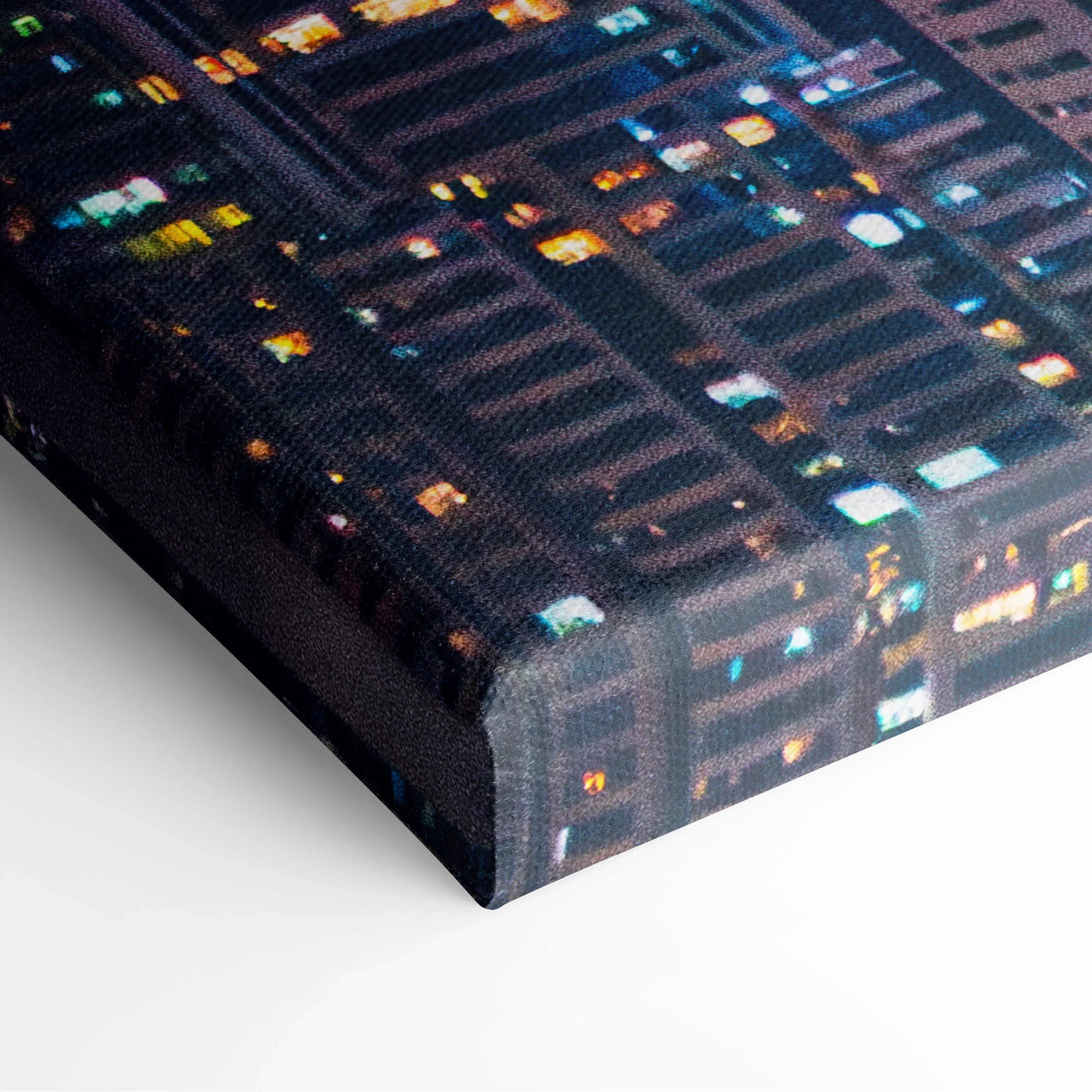 Stretched canvas wall art featuring high-resolution digital architecture with illuminated windows on a dark modern building.