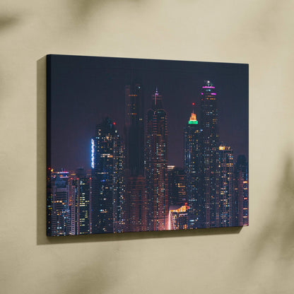 City skyline at night with illuminated skyscrapers on canvas wall art.