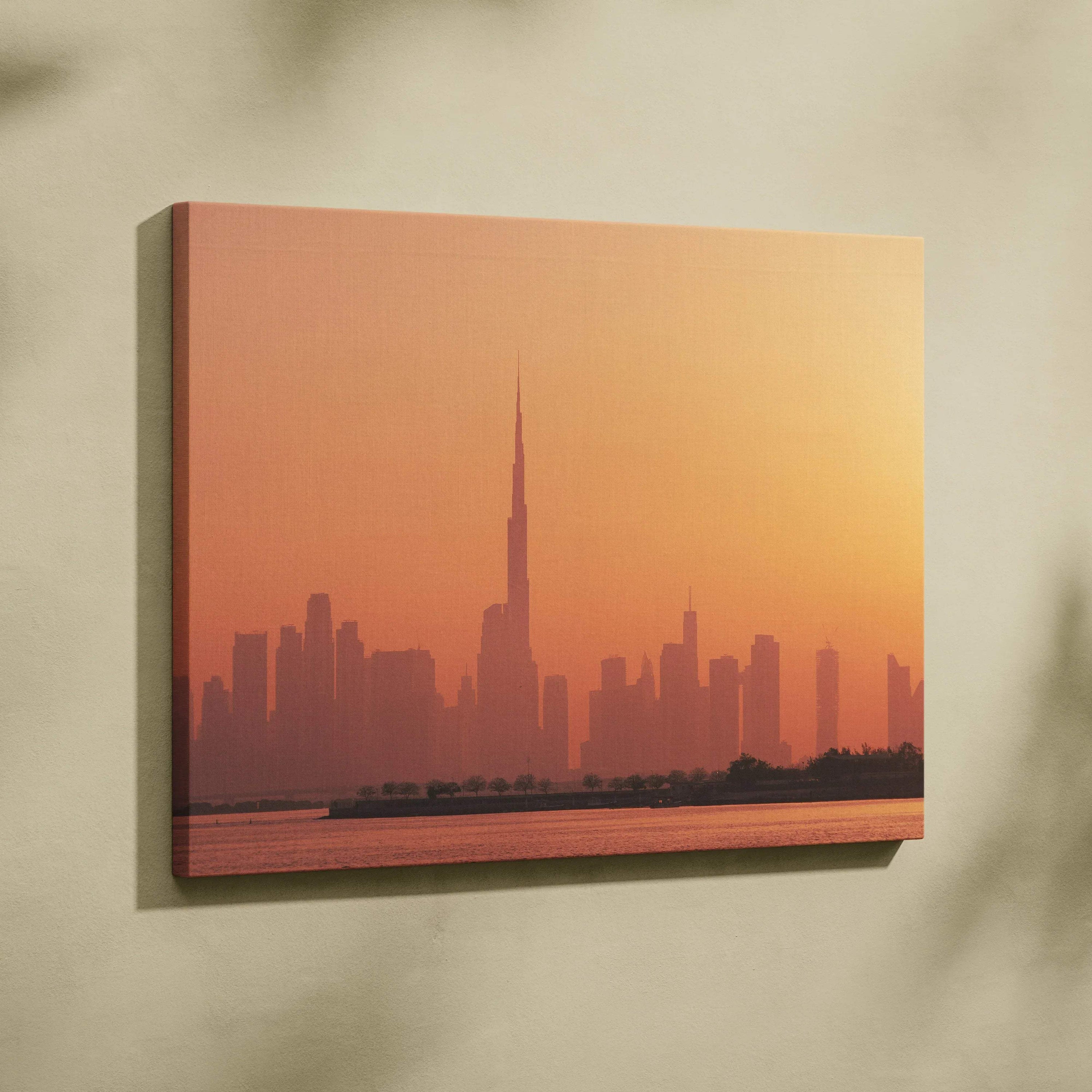 Canvas wall art featuring a warm-toned city skyline with a tall, pointed skyscraper at sunset.