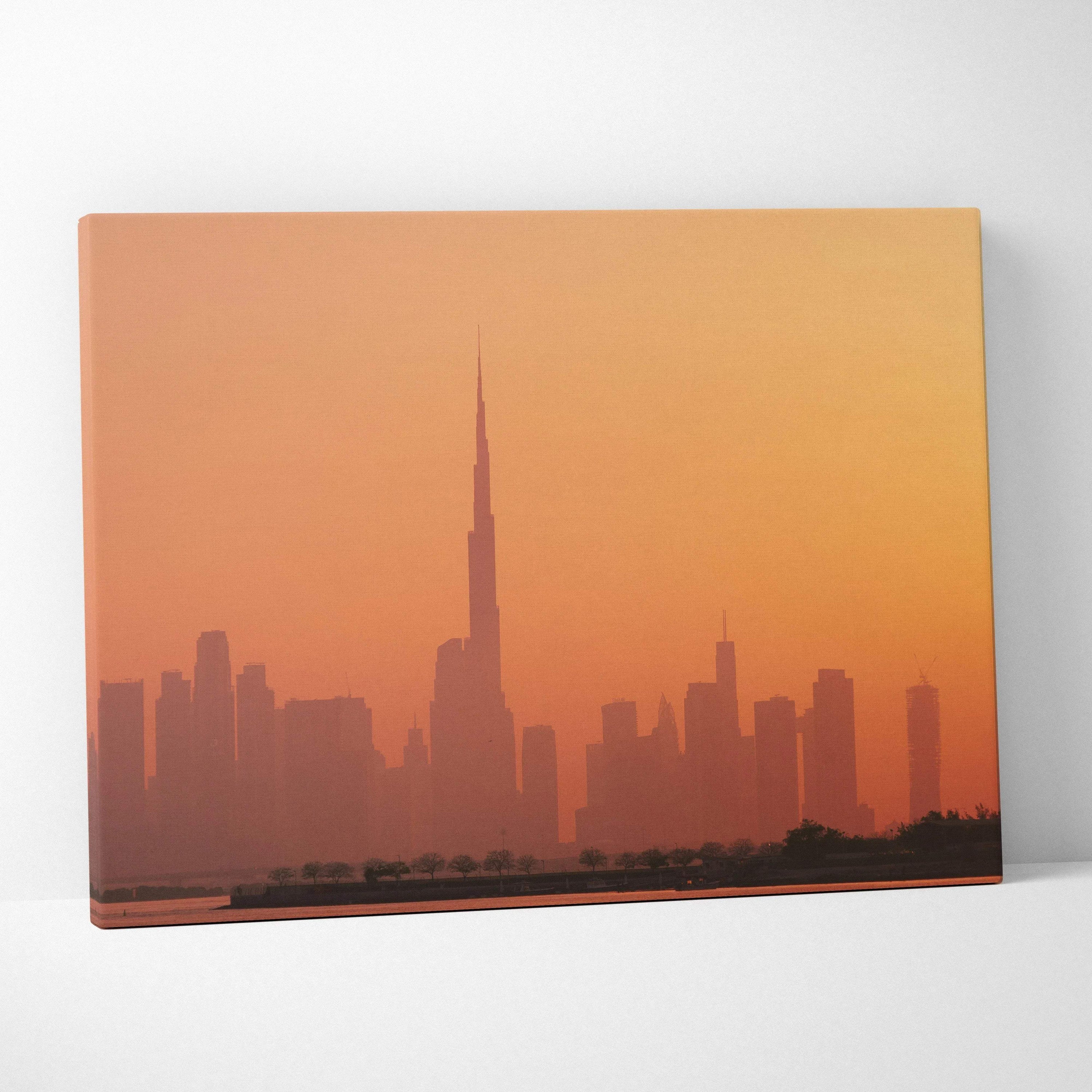Canvas wall art print featuring a city skyline silhouette at sunset with warm orange tones.