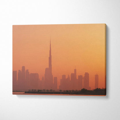 Sunset city skyline canvas wall art with tall buildings in warm orange tones.