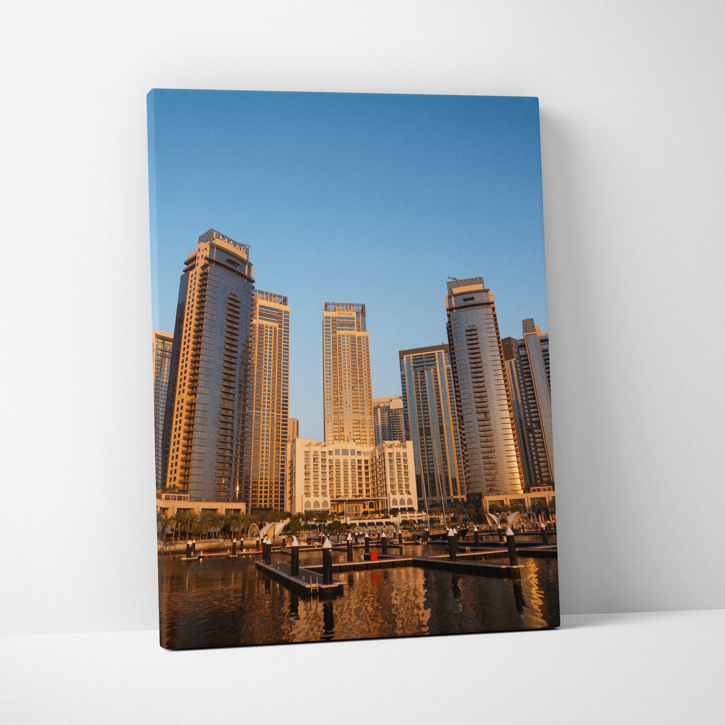 Canvas wall art featuring modern skyscrapers at sunset with reflective water, vertical cityscape art.