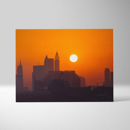 Canvas wall art featuring a digital art city skyline silhouette with an orange sunset background.