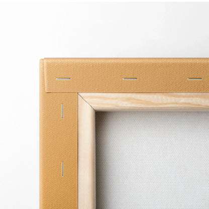 Close-up of natural wood stretcher frame with beige canvas stretched and stapled on back for wall art.