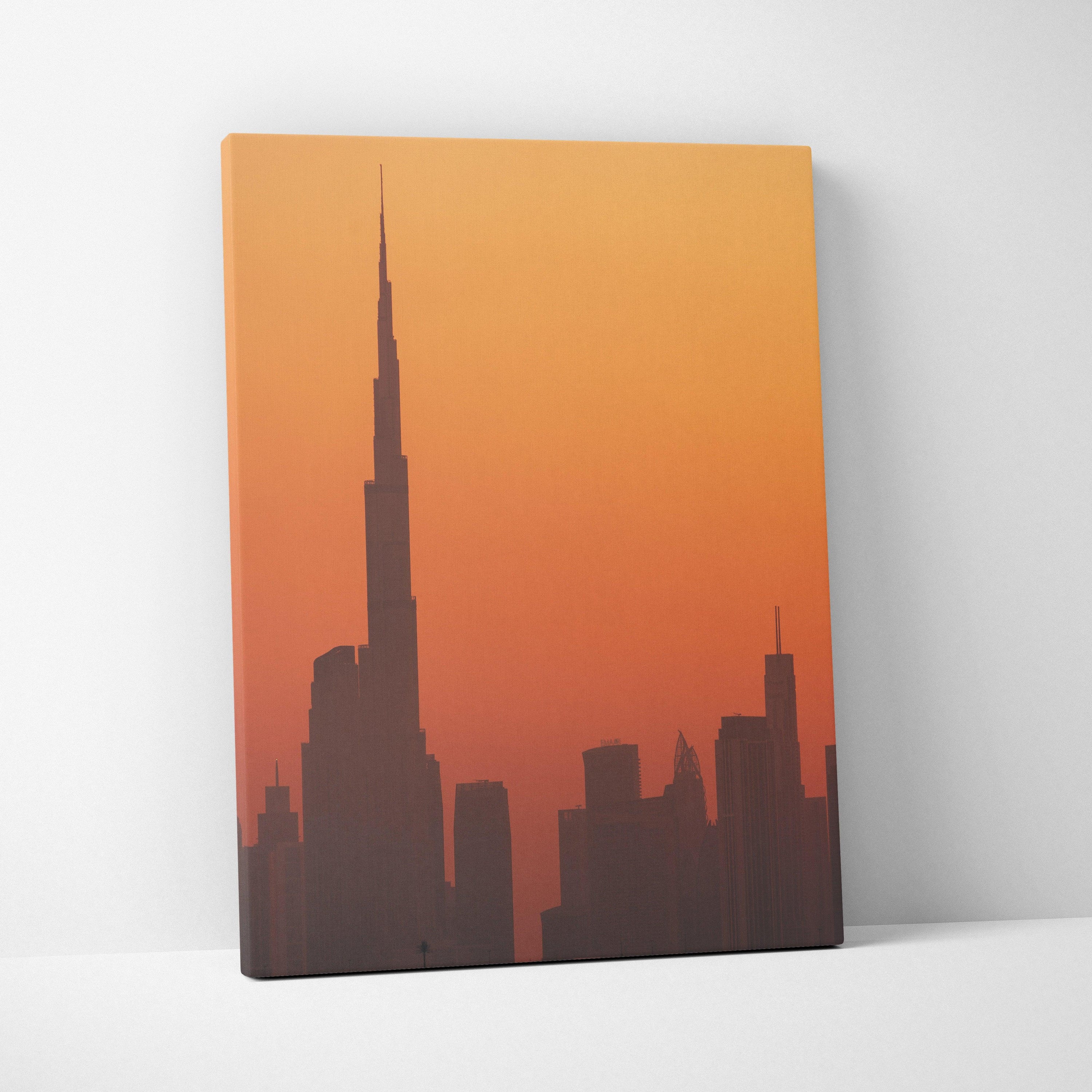 Canvas wall art featuring a silhouette of a city skyline against an orange gradient sky.