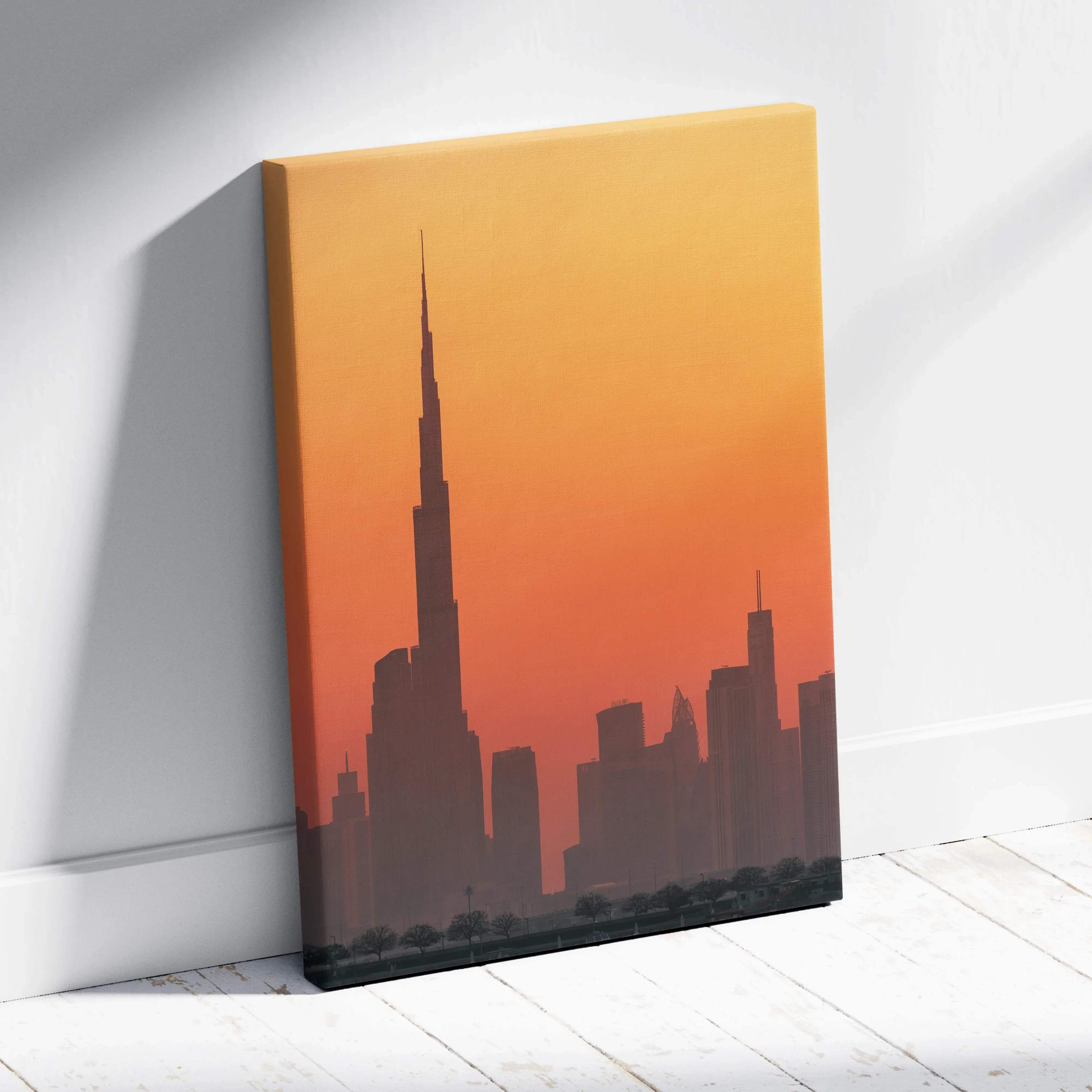A canvas wall art featuring dubai skyline silhouette with burj khalifa in warm orange and yellow sunset colors