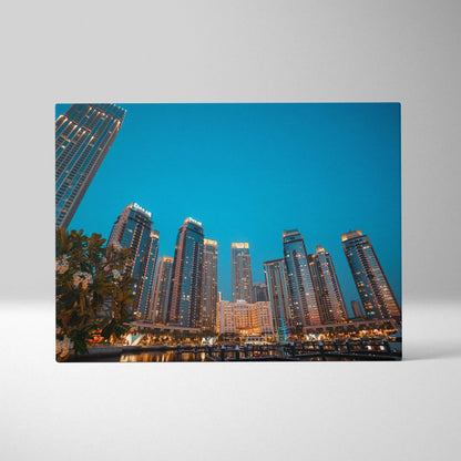 Canvas wall art featuring a vibrant city skyline with illuminated modern skyscrapers at dusk.