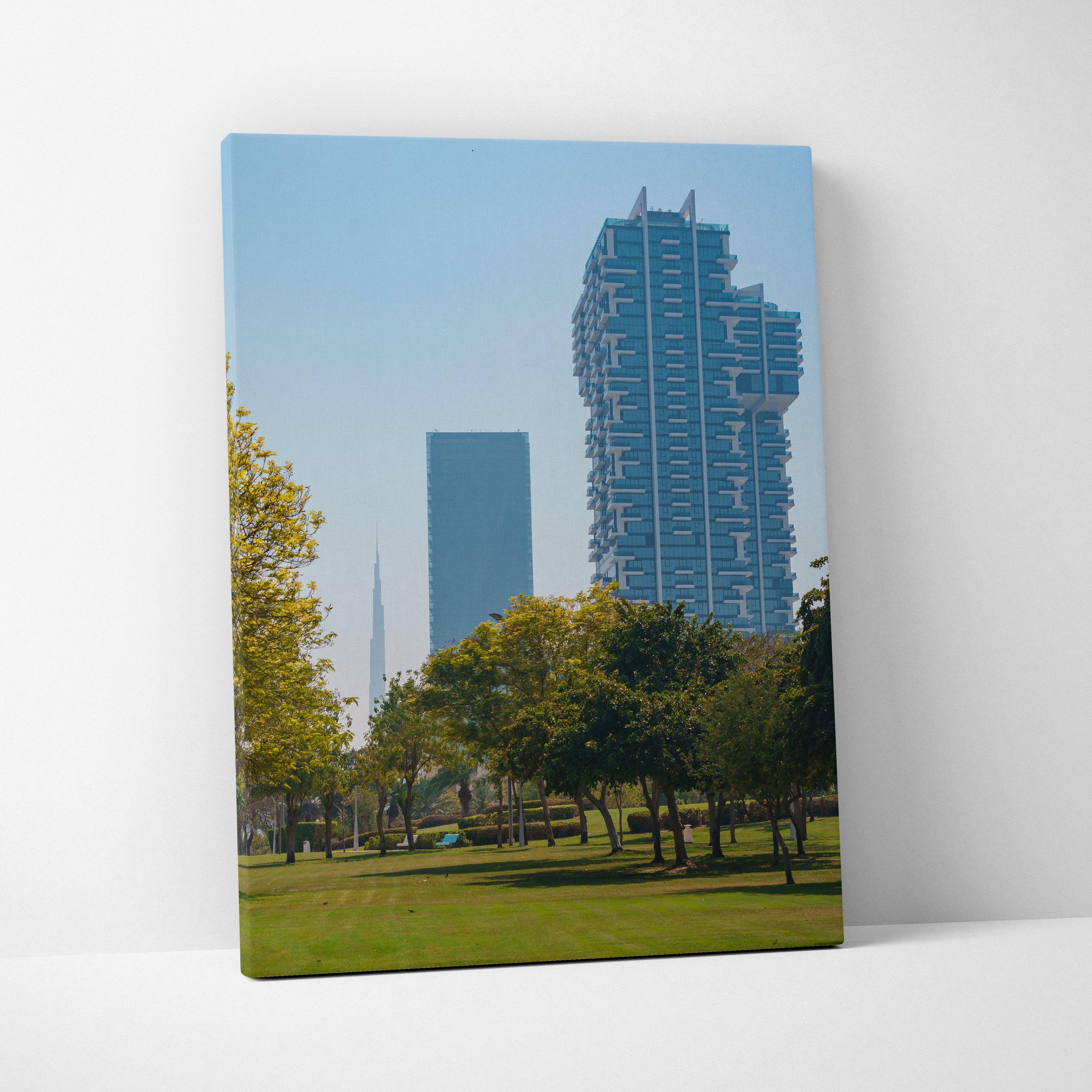Canvas wall art featuring digital architecture of two modern skyscrapers against a clear blue sky with green park trees.