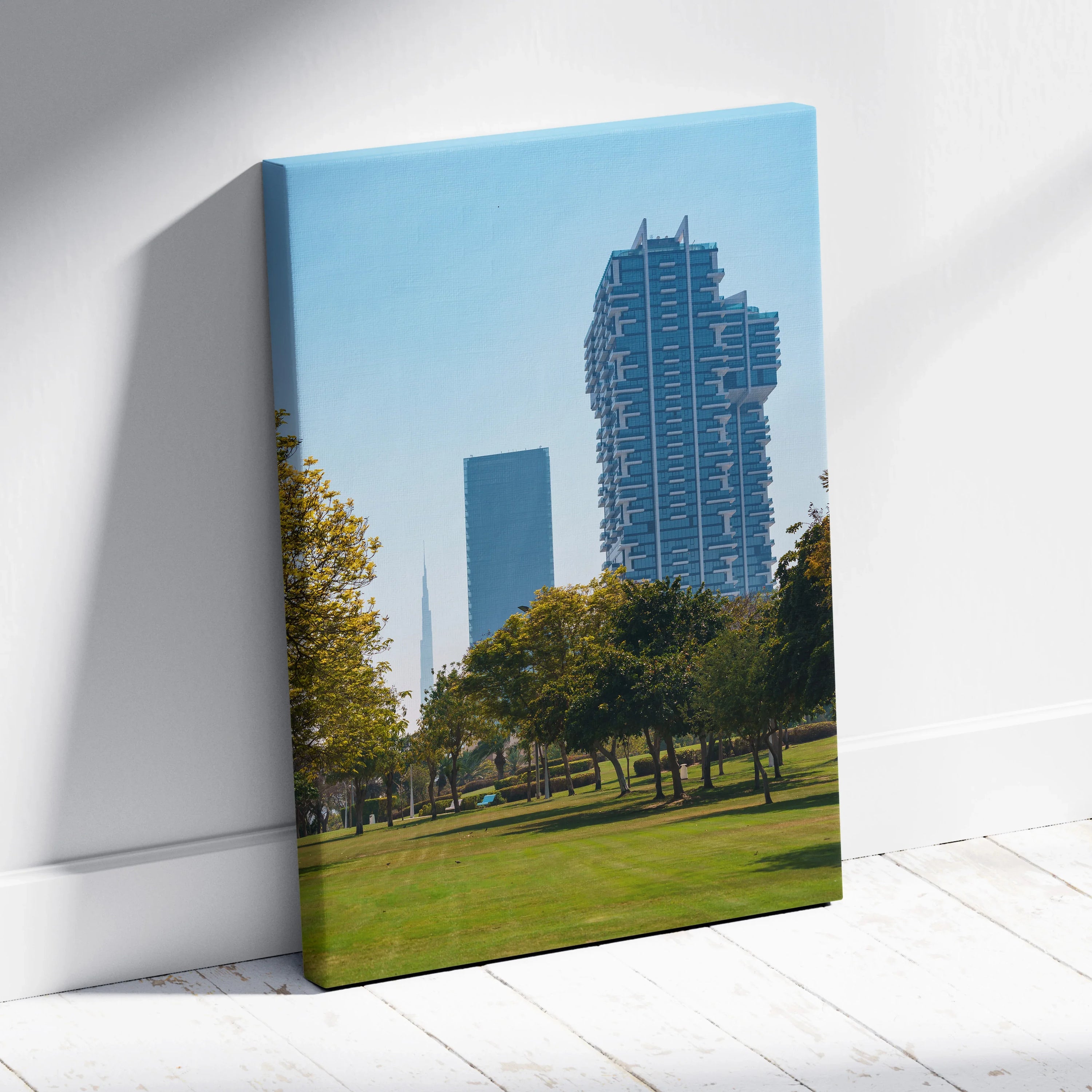 Canvas wall art featuring modern skyscrapers with blue sky and green park foreground.