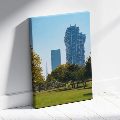 Canvas wall art featuring modern skyscrapers with blue sky and green park foreground.