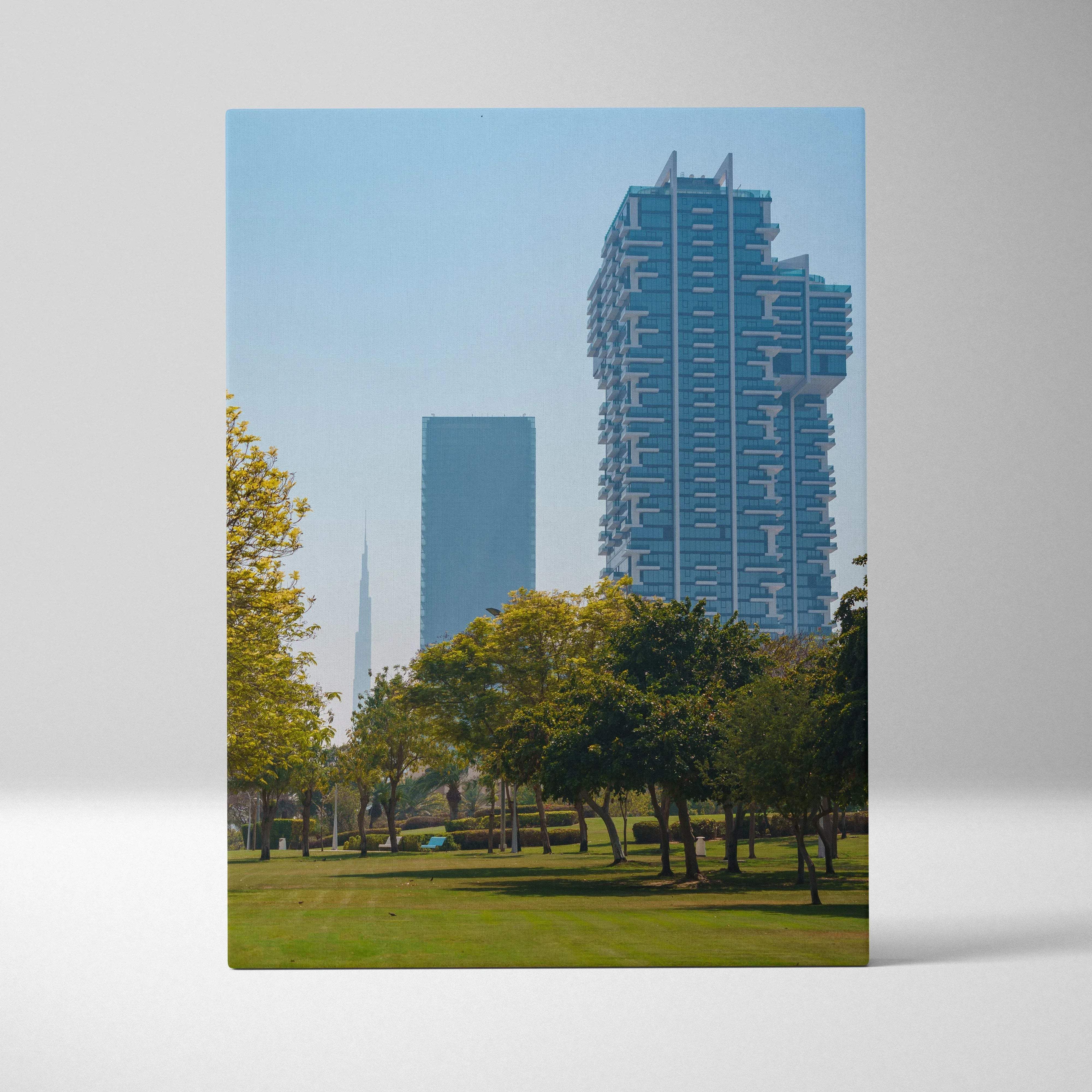 Architectural cityscape canvas wall art showing blue-tinted skyscrapers and green trees under a clear sky