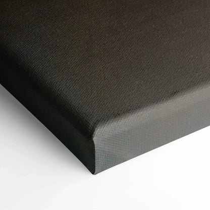 Close-up of black textured canvas corner on stretched frame for wall art decor.