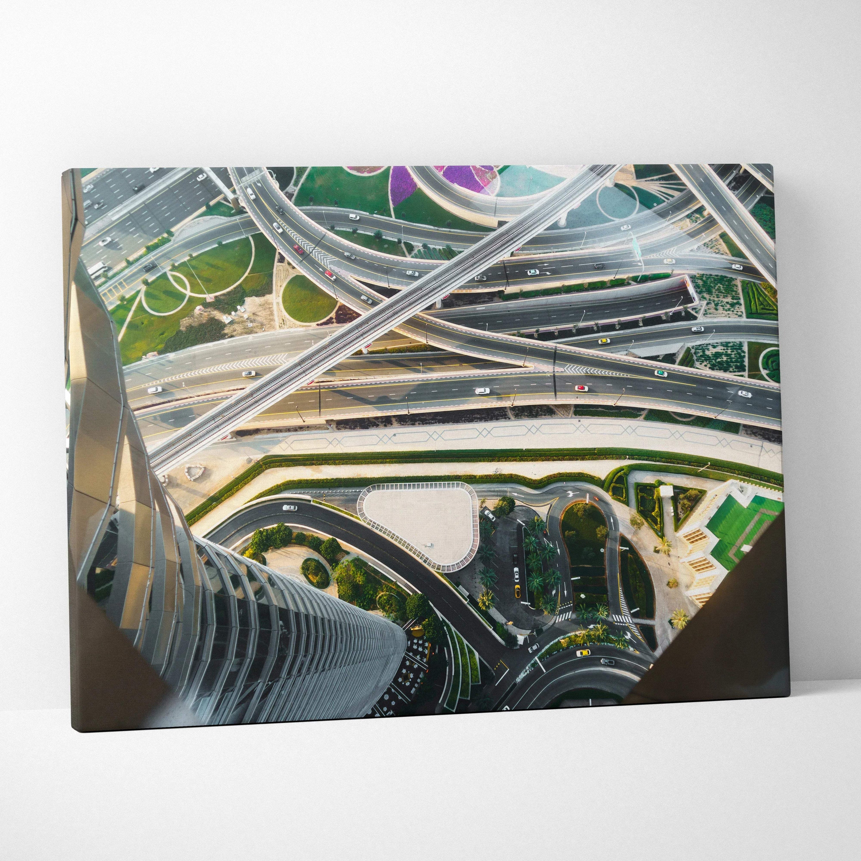 Aerial view canvas art depicting modern architectural highways and tall buildings in green and gray tones.