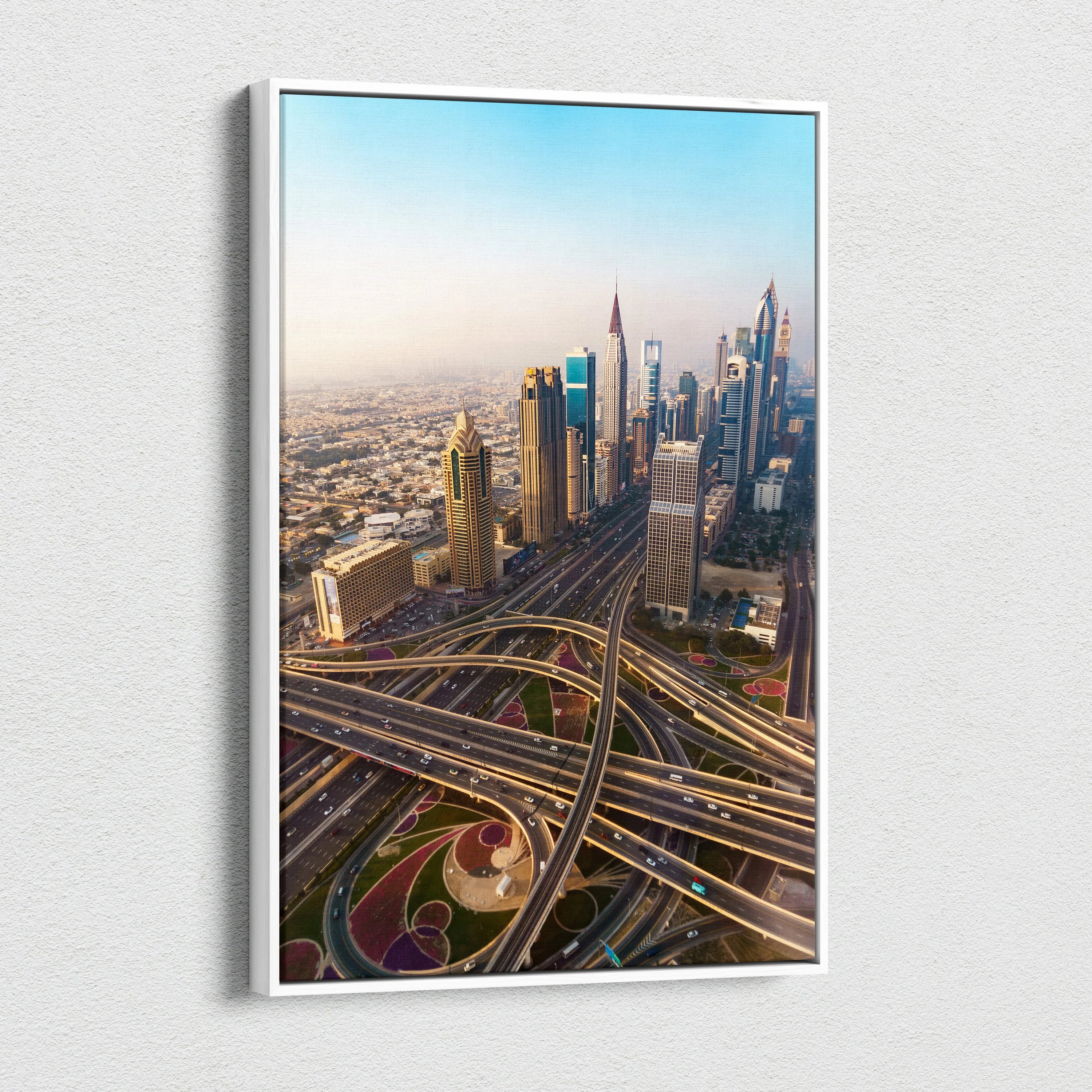 Modern cityscape canvas wall art featuring skyscrapers and intricate highway overpasses in warm sunlight.