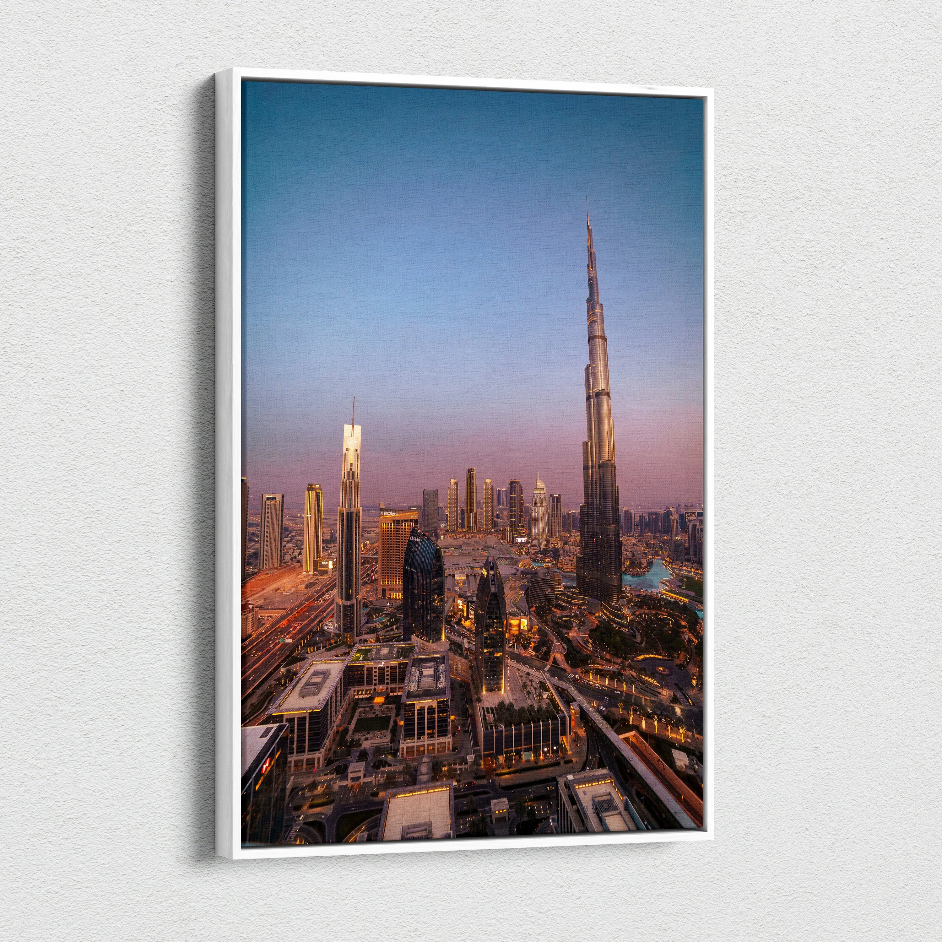 Tall canvas wall art featuring a cityscape with illuminated buildings at dusk, highlighted by the Burj Khalifa tower.