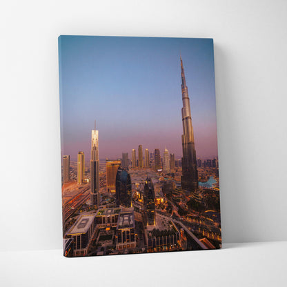 Tall canvas wall art print featuring illuminated city skyline with modern skyscrapers at dusk.
