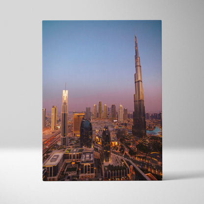 Vertical canvas wall art featuring a sunset city skyline with illuminated skyscrapers including a tall iconic tower.