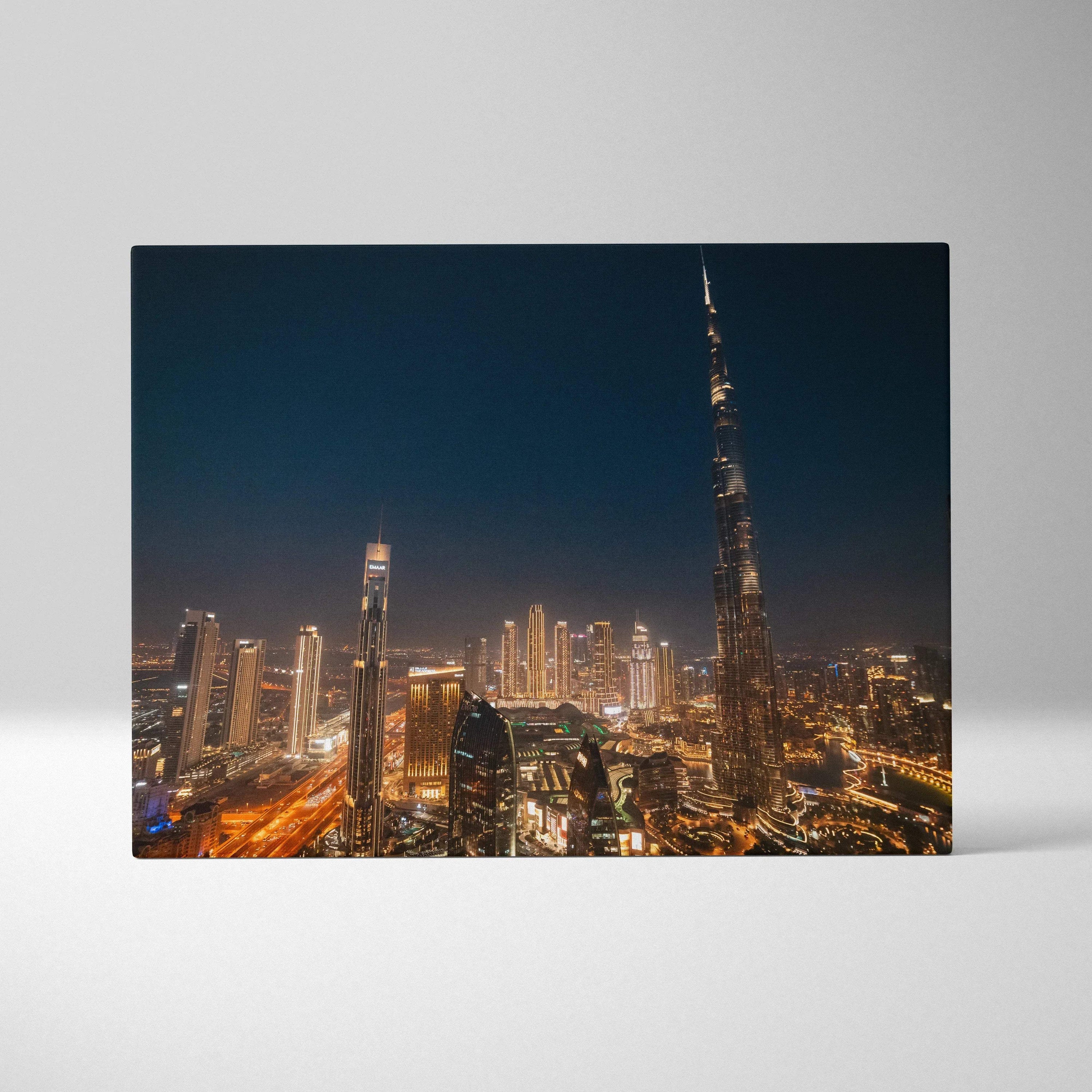 Nighttime city skyline with illuminated skyscrapers on a stretched canvas art print.