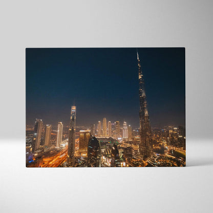 Nighttime city skyline with illuminated skyscrapers on a stretched canvas art print.