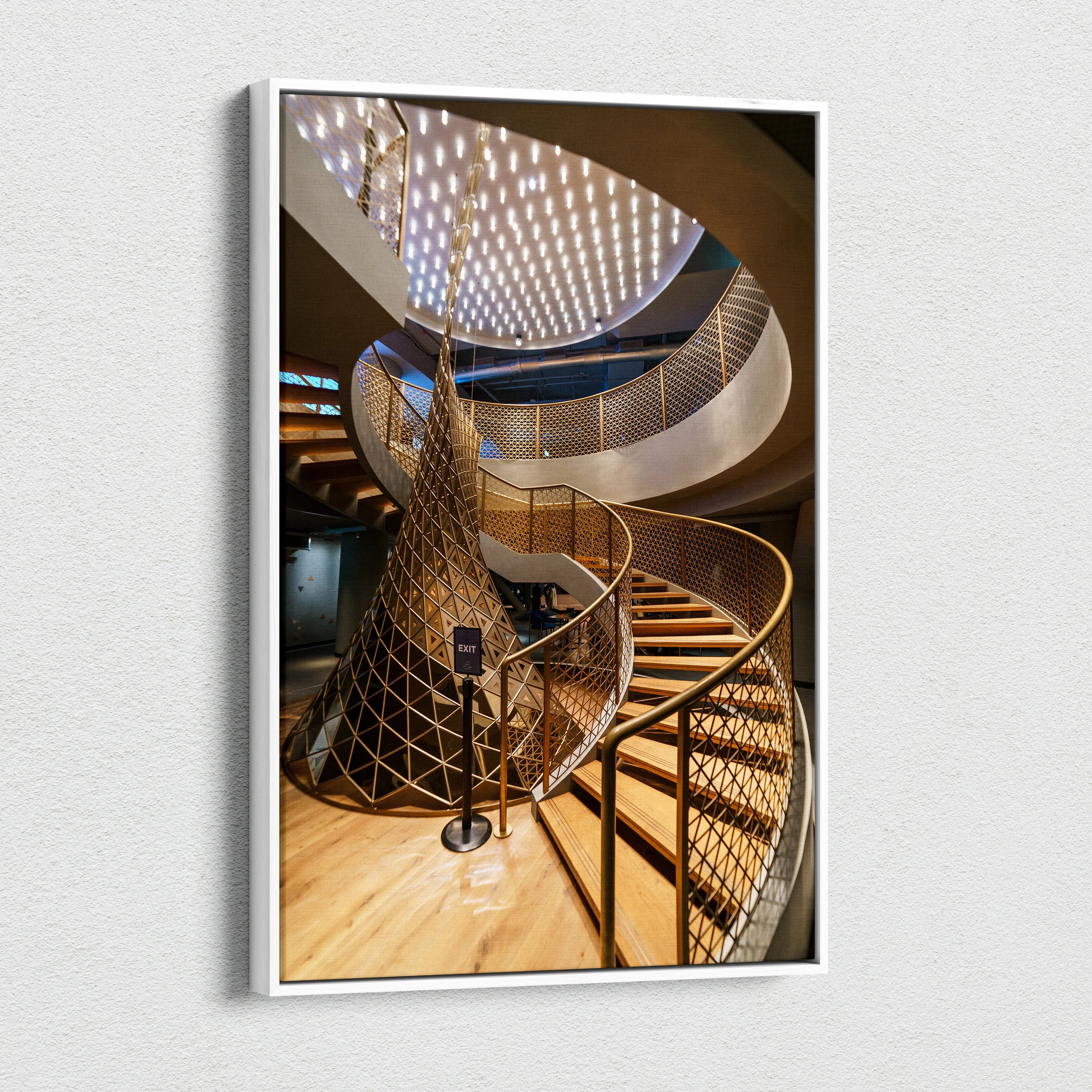 Canvas wall art featuring a spiral staircase with golden railings and geometric ceiling light patterns in a modern.