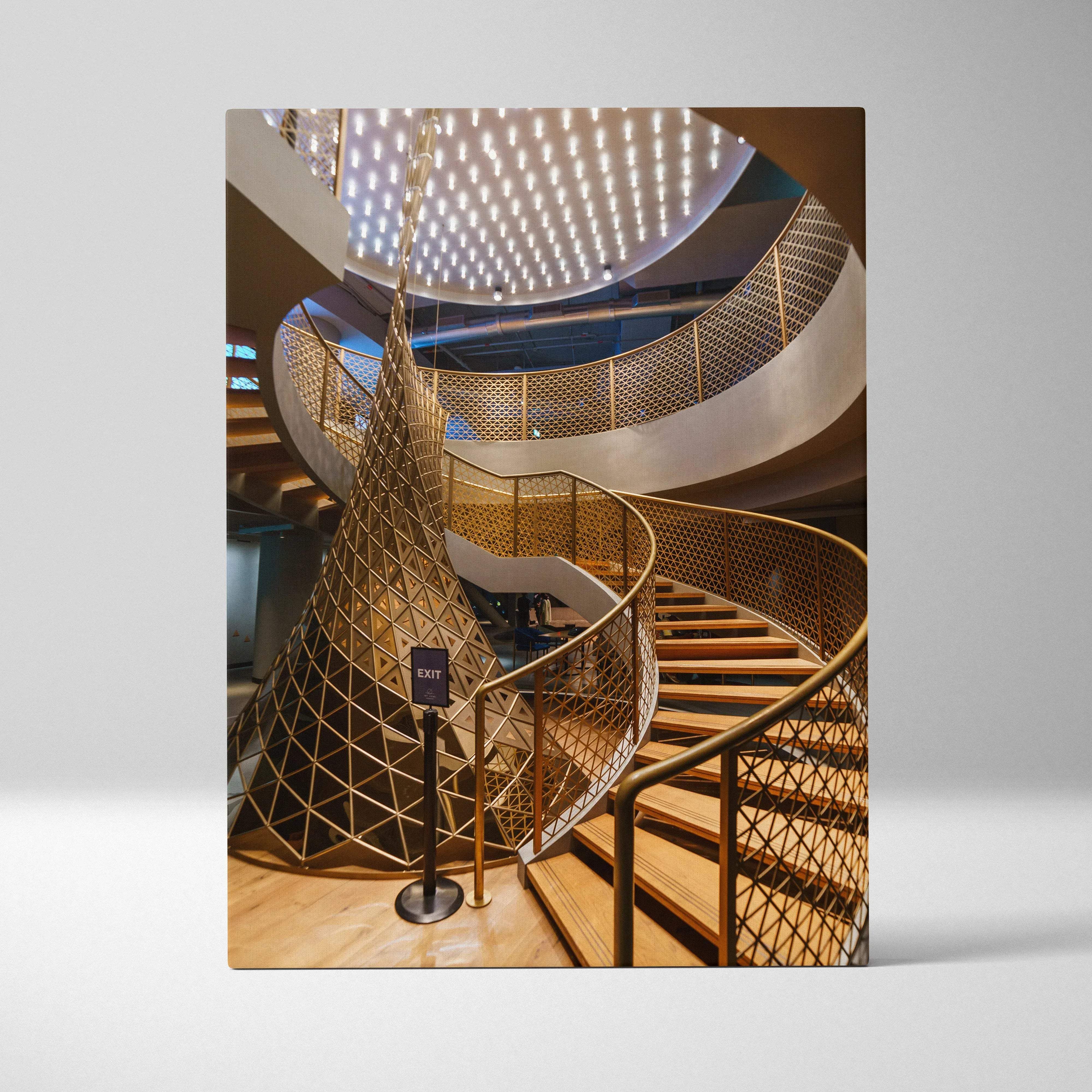 Modern architectural interior spiral staircase with golden geometric lattice railings and warm wooden steps wall art