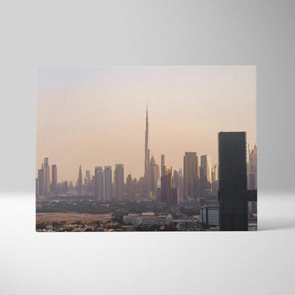 Canvas wall art featuring a soft pastel city skyline with a prominent tall skyscraper at sunset.