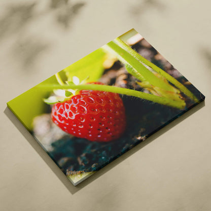 Vibrant strawberry close-up on canvas wall art with bright green leaves and natural decor background.
