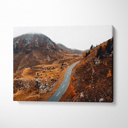 Canvas wall art of a winding road through brown autumn hills under a gray sky.