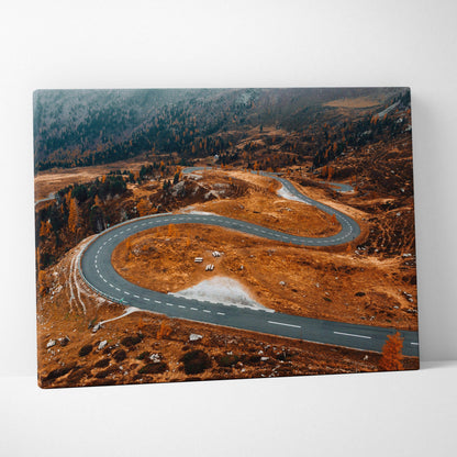 Autumn winding road through vibrant orange and brown foliage on canvas wall art.