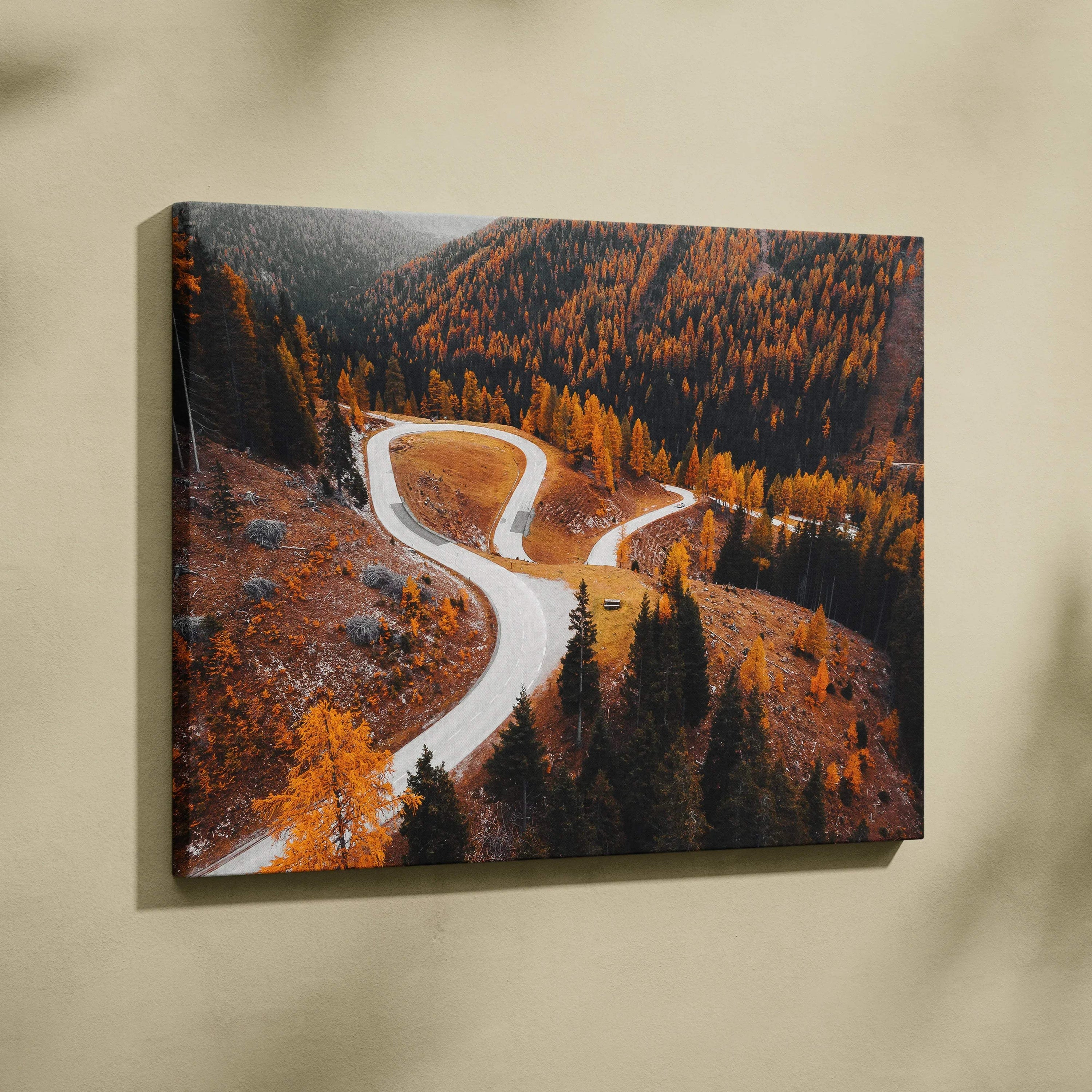 Vibrant autumn digital art canvas showing winding road surrounded by golden and orange fall trees wall art.