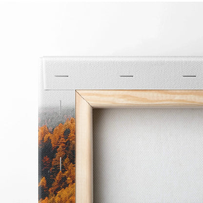 Corner detail of canvas wall art with vibrant autumn trees and wooden frame edge.