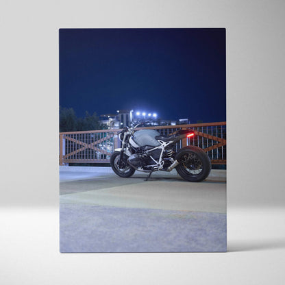 BMW R Nine T motorcycle at night on urban canvas wall art, high-resolution vertical print.