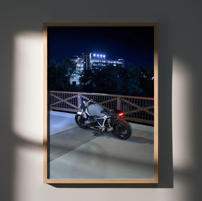 BMW R Nine T motorcycle parked at night with illuminated building background poster wall art.