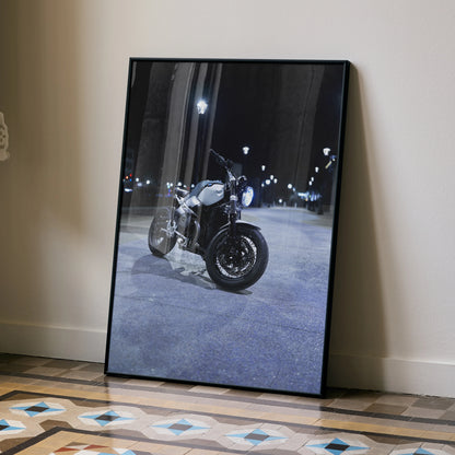 BMW R Nine T motorcycle poster in black frame leaning on wall, night street scene wall art.