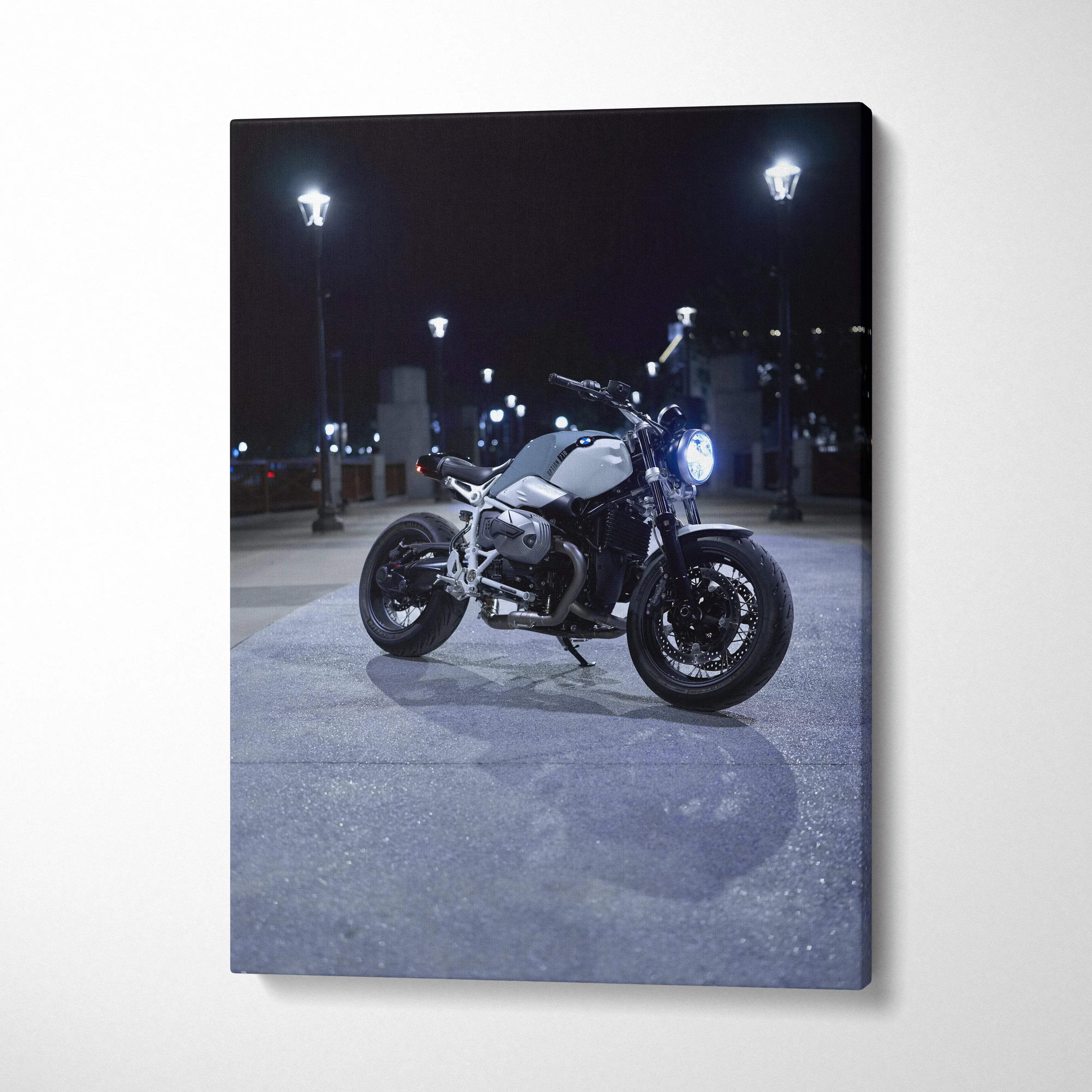 BMW R Nine T motorcycle lit at night on street canvas wall art in vertical format.