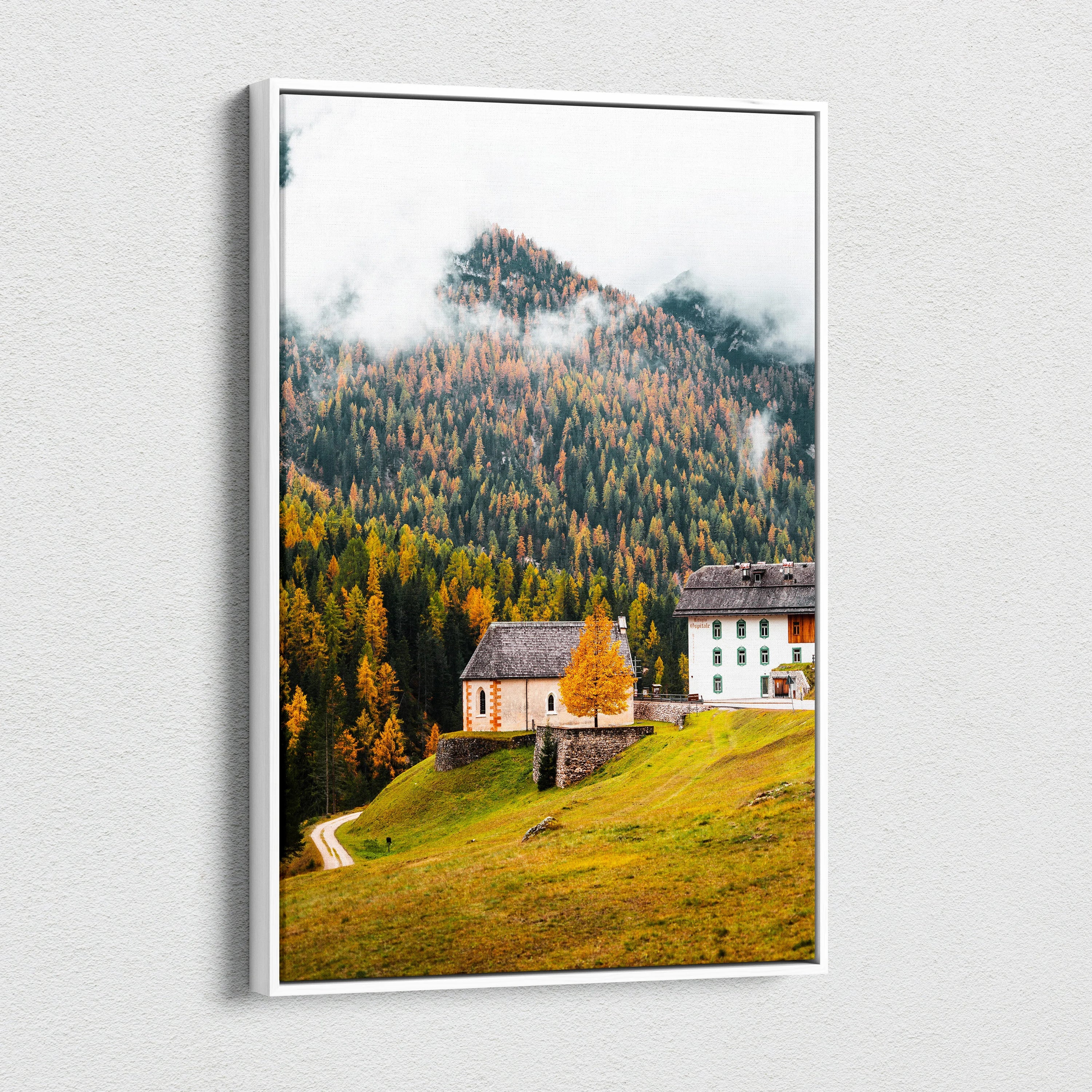 Canvas wall art featuring a serene mountain village with autumn trees and misty peaks in warm tones.